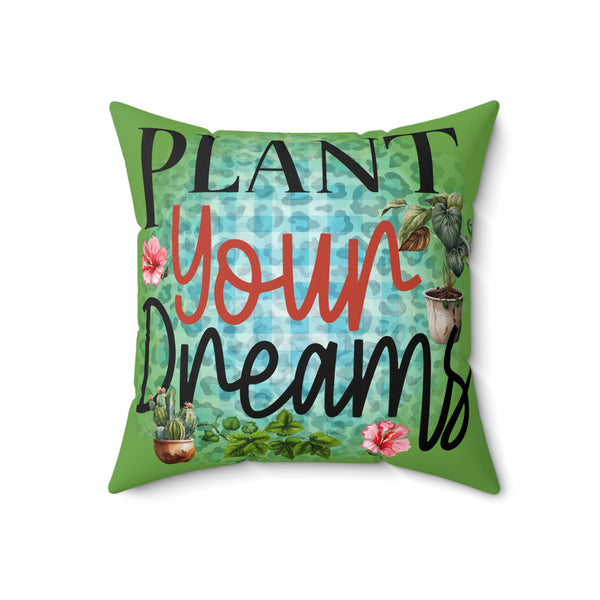 Decorative pillow with 'Plant Your Dreams' text and plant illustrations on a green background