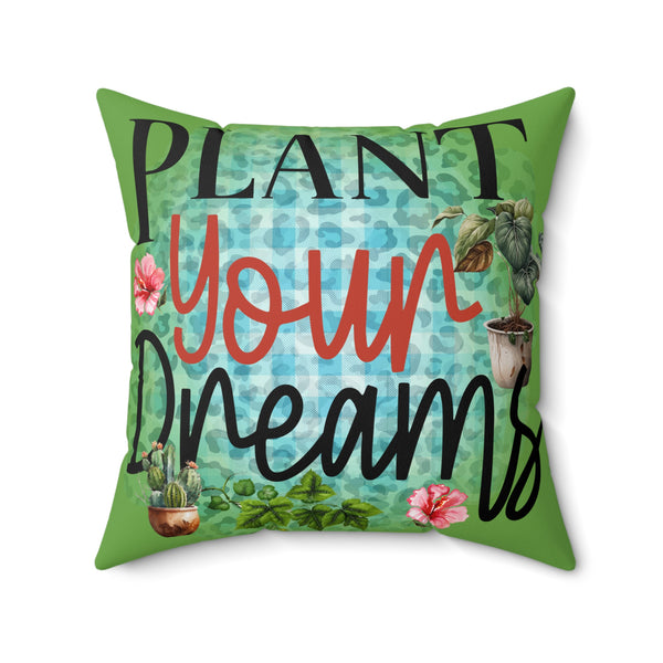 Decorative pillow with 'Plant Your Dreams' text and plant illustrations on a green background