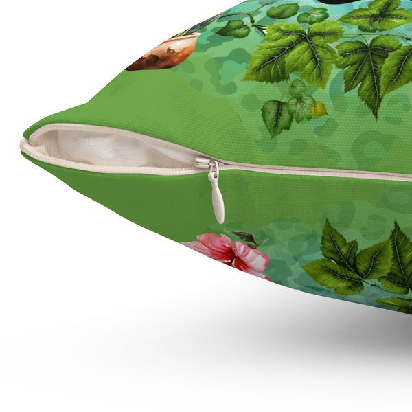 Green pillow with floral and leaf pattern on a white background