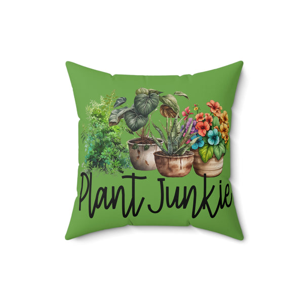 Green pillow with plant illustrations and 'Plant Junkie' text on a white background