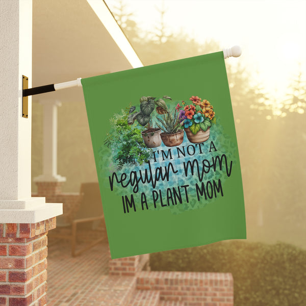 Decorative garden flag with plant-themed text hanging on a porch.