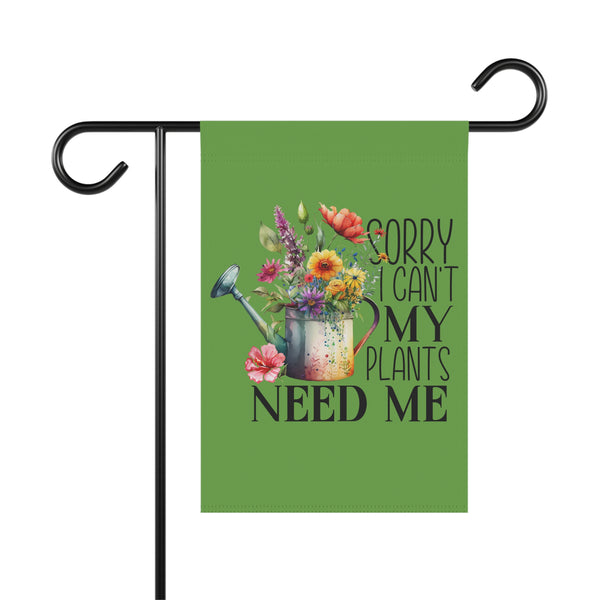 Decorative garden flag with a watering can and flowers design on a green background, featuring the text 'Sorry can't my plants need me'.