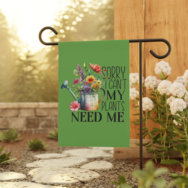 Decorative garden flag with floral design and text on a stand outdoors.