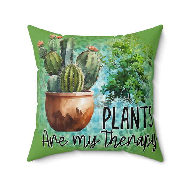 Decorative pillow with cactus illustration and 'Plants are my therapy' text on a green background