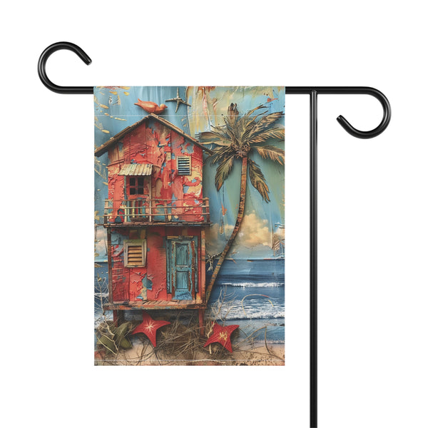 Decorative garden flag with a red hut, palm tree, and ocean scene on a white background.