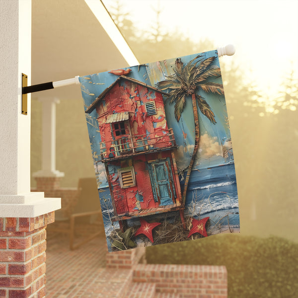 Decorative towel with a colorful house and palm tree design hanging on a door handle.