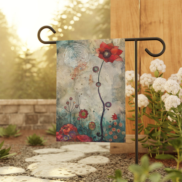 Decorative garden flag with floral design on a stand outdoors.