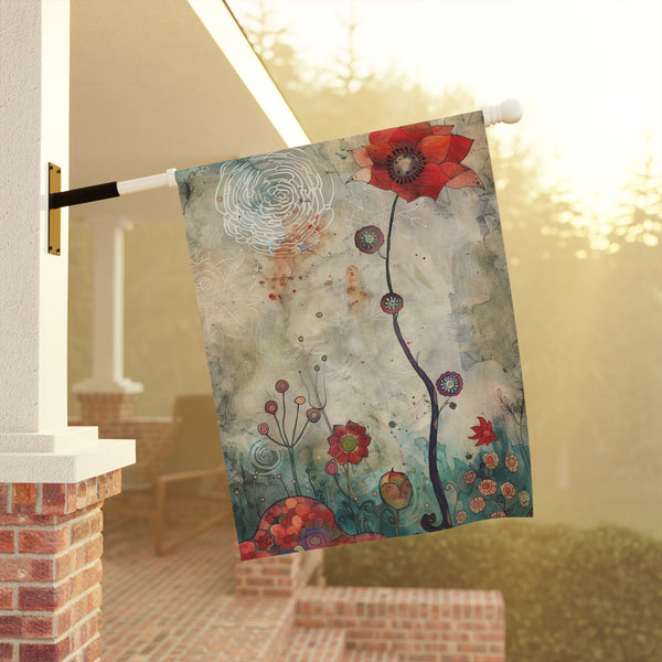 Decorative garden flag with floral design hanging on a pole outdoors.