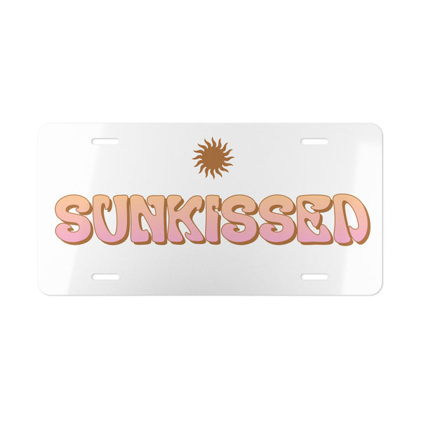 License plate with 'SUNKISSED' text and sun graphic on a white background