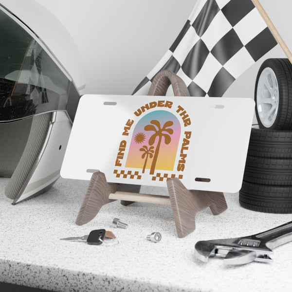 License plate with palm tree design on a stand, surrounded by car parts and tools.