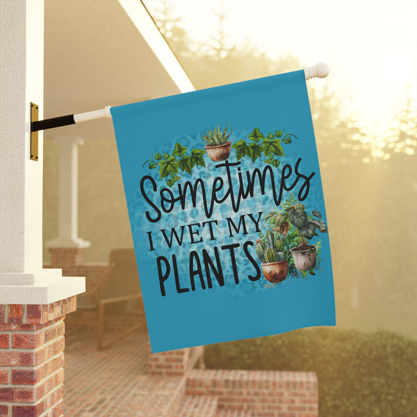 Decorative garden flag with plant-themed text and illustrations on a porch background