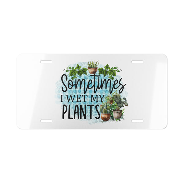 License plate with plant-themed design and text 'Sometimes I wet my plants' on a white background