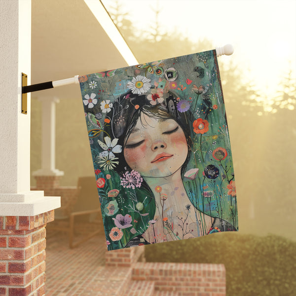 Decorative flag with a floral design and a girl's face, hanging on a porch.