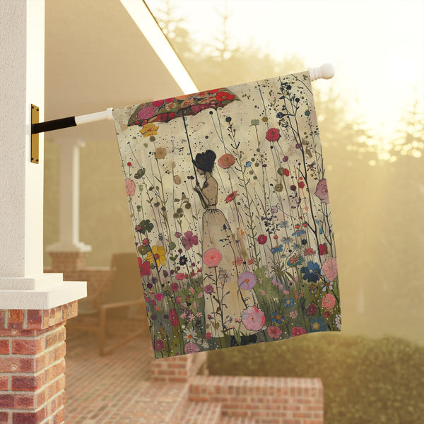 Decorative flag with a woman and floral design hanging on a pole outdoors.