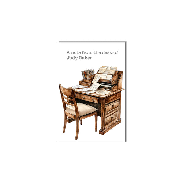 Wooden desk with chair and stationery, labeled 'A note from the desk of Judy Baker'.