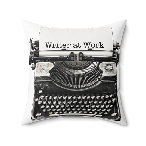 Pillow with a typewriter design and 'Writer at Work' text on a white background