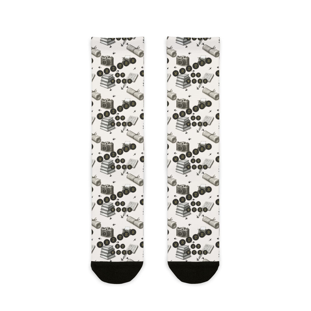 Pair of socks with a pattern of black and white shapes on a white background