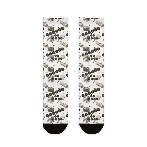 Pair of socks with a pattern of black and white shapes on a white background