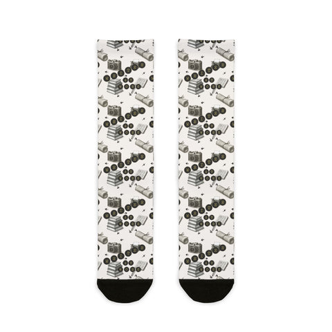 Pair of socks with a pattern of black and white shapes on a white background