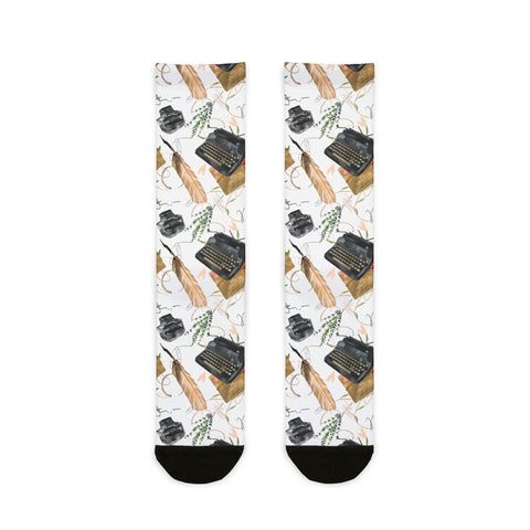 Socks with typewriter and feather pattern on a white background