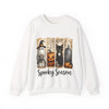 White sweatshirt with Halloween-themed design featuring a ghost, pumpkin, cat, and tombstone on a white background.