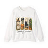 White sweatshirt with Halloween-themed design featuring a black cat, jack-o'-lantern, and witch hat on a white background.