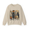 Beige sweatshirt with Halloween-themed design featuring ghost, cat, skeleton, and owl on a white background.