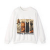 White sweatshirt with Halloween-themed design featuring pumpkins, ghosts, and a black cat on a white background.