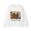 White sweatshirt with Halloween-themed design featuring a pumpkin, witch, and ghost with 'Hocus Pocus' text.