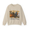Beige sweatshirt with Halloween-themed design featuring a witch, ghost, and pumpkin.