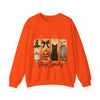 Orange sweatshirt with Halloween-themed design featuring a witch, black cat, pumpkin, and archway on a white background.