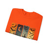 Folded orange t-shirt with Halloween-themed design featuring bats and a moon on a white background