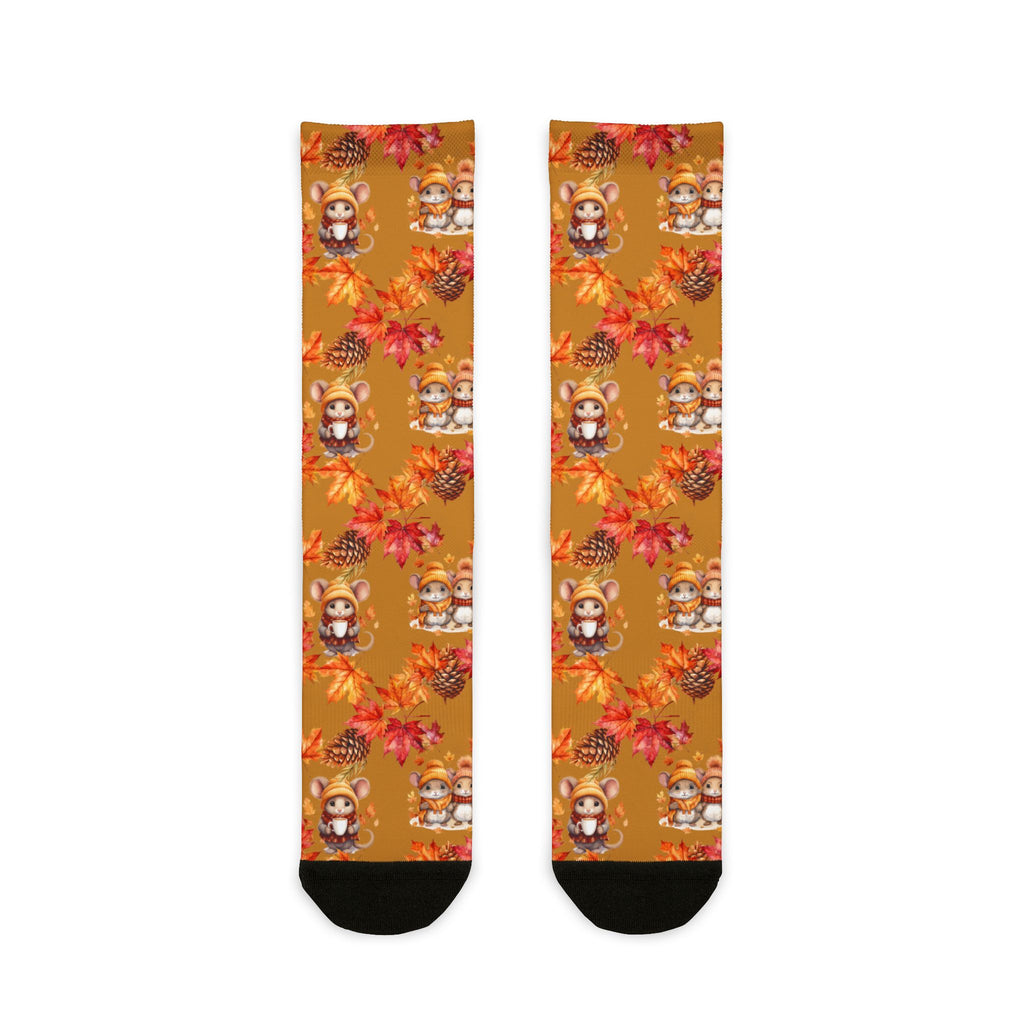 Pair of socks with autumn-themed design featuring leaves and animals on a white background