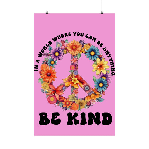 Poster with a peace symbol made of flowers and text 'In a world where you can be anything, be kind' on a pink background.