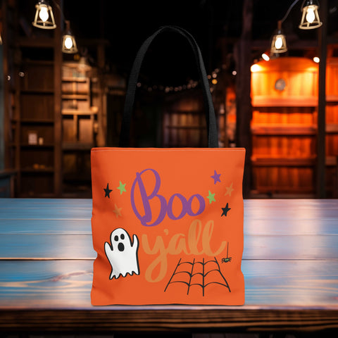 Boo Y'all Halloween Trick or Treat Bag sitting on the edge of a table in a dark room