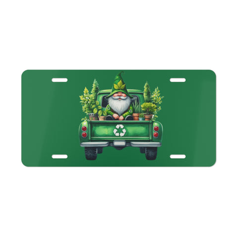 Green license plate with a gnome driving a truck carrying plants on a white background