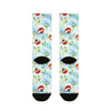 Pair of socks with ladybug and flower pattern on a white background