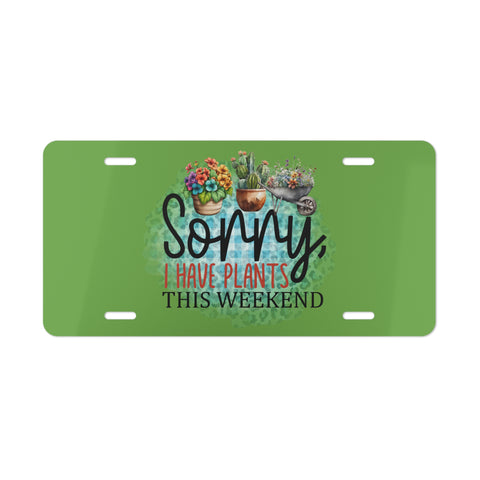 Green license plate with plant-themed design and text on a white background