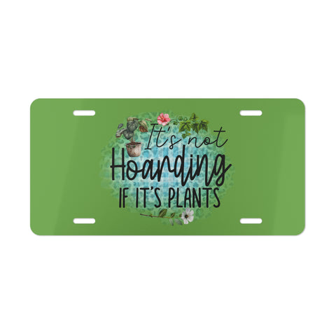 Green license plate with plant-themed text and illustrations on a white background
