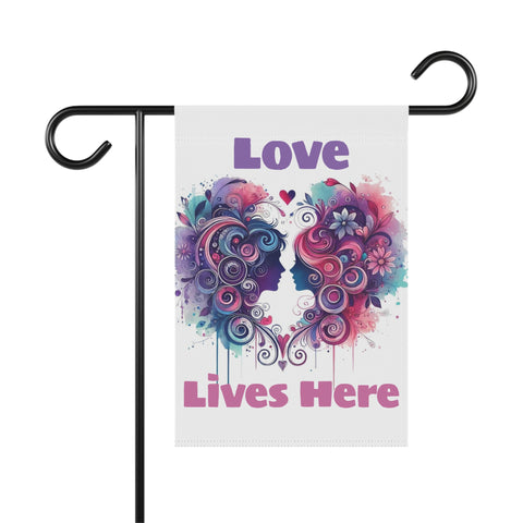 Decorative garden flag with colorful heart design and 'Love Lives Here' text on a white background.