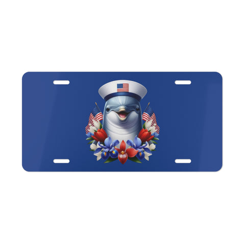 License plate with a dolphin wearing a sailor hat and surrounded by American flags and flowers on a blue background.