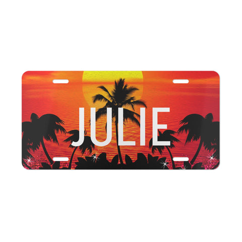 License plate with 'JULIE' and palm tree design against a sunset background