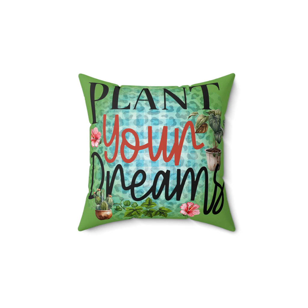 Decorative pillow with 'Plant Your Dreams' text and gardening-themed design on a white background