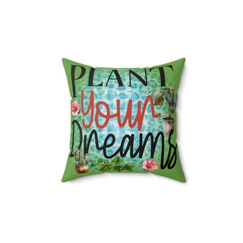 Decorative pillow with 'Plant Your Dreams' text and gardening-themed design on a white background
