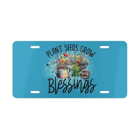 Blue license plate with garden-themed design and text 'Plant Seeds Grow Blessings' on a white background