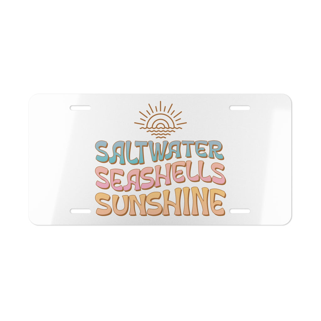 License plate with 'Saltwater Seashells Sunshine' text and sun graphic on a white background