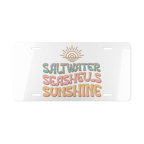 License plate with 'Saltwater Seashells Sunshine' text and sun graphic on a white background