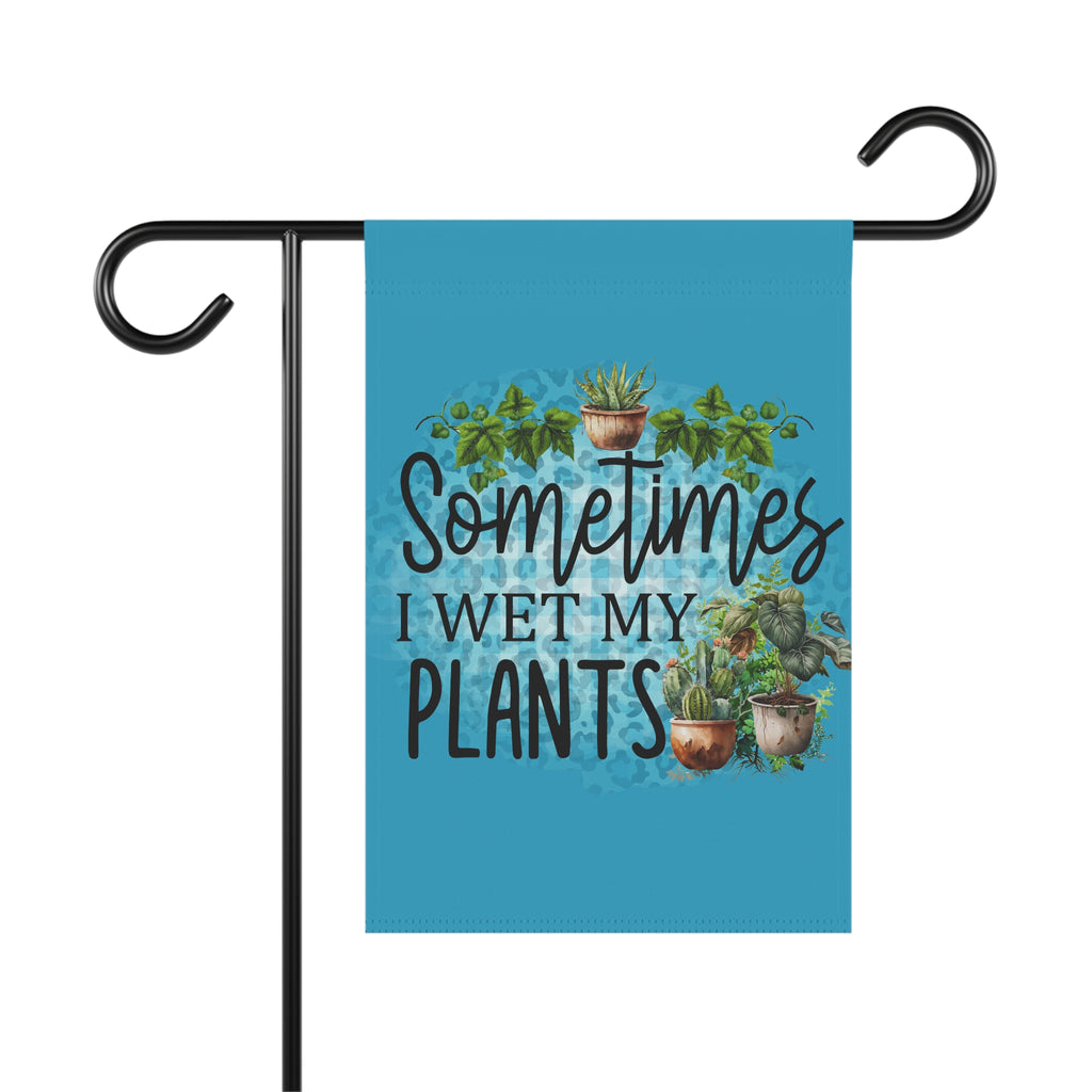 Garden flag with plant-themed text and illustrations on a blue background, attached to a flagpole.