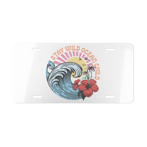 License plate with ocean-themed design featuring a wave, flowers, and text on a white background